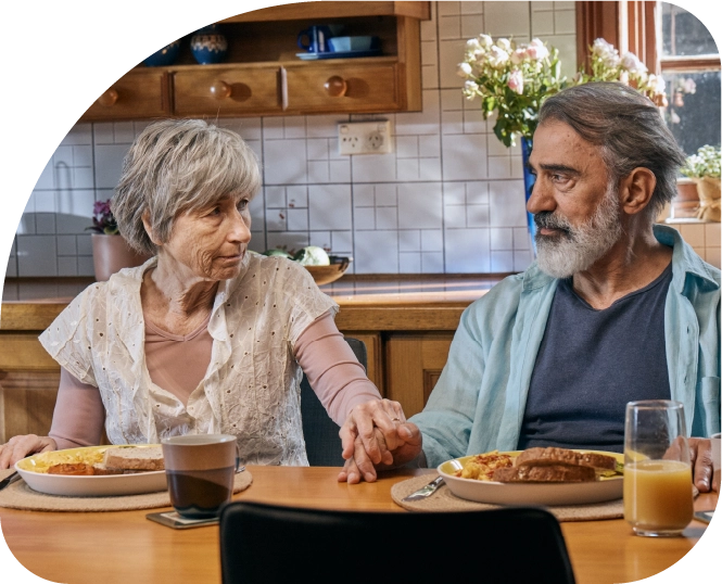 Woman with dementia having breakfast with husband